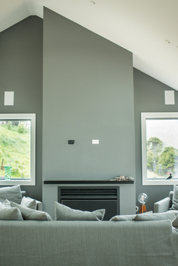 Picture of a modern living room with gray walls and white windows