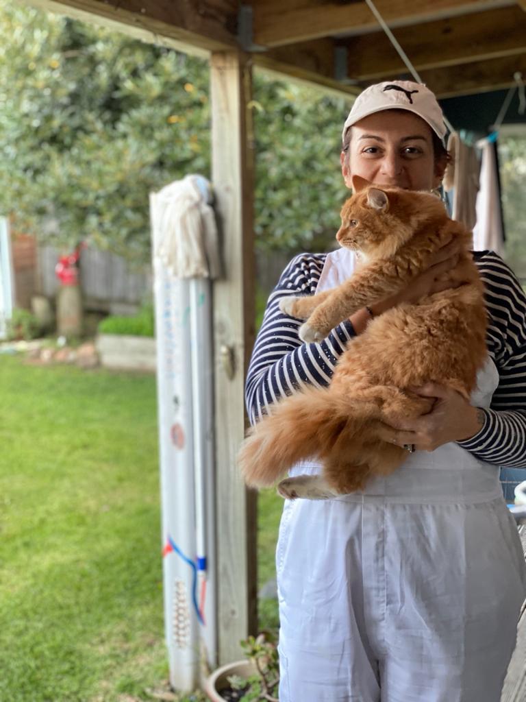 Rosa at work holding a cat